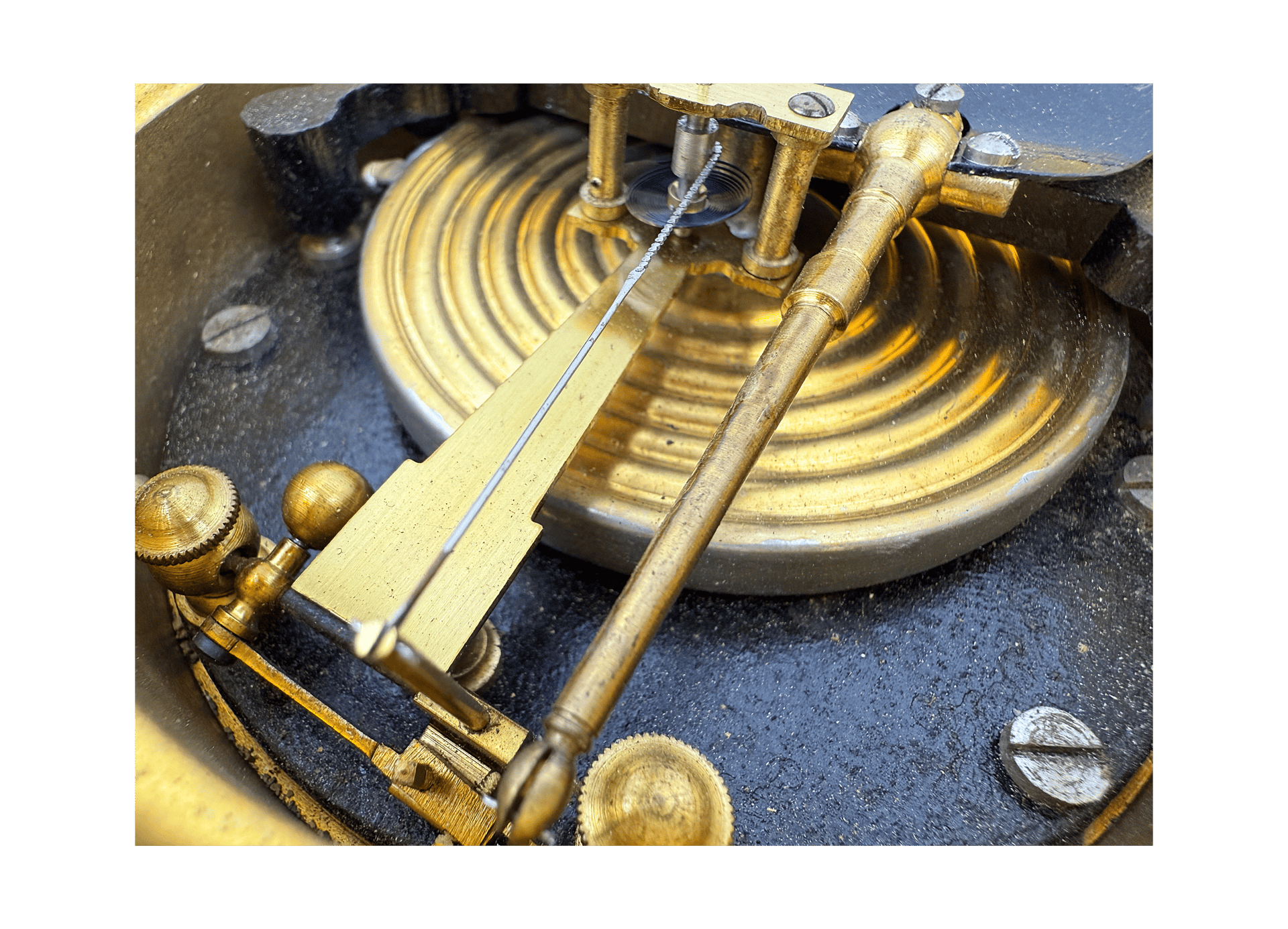 Early aneroid barometer on a wooden stand